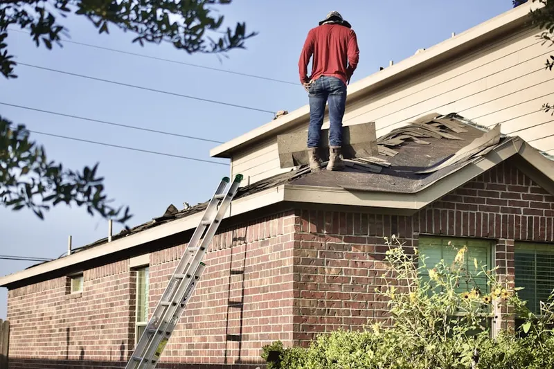 Professional roofer working on a residential roof in Goldvein